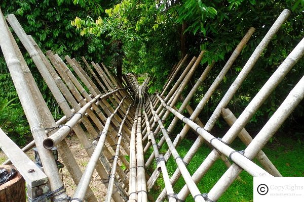 A bamboo walkway connecting various sections of the village