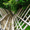 A bamboo walkway connecting various sections of the village